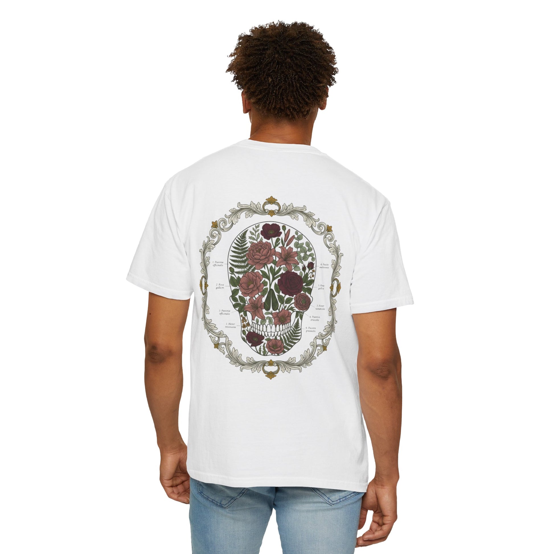 Floral skull framed in botanical scrollwork printed on the back of a garment-dyed cotton tee