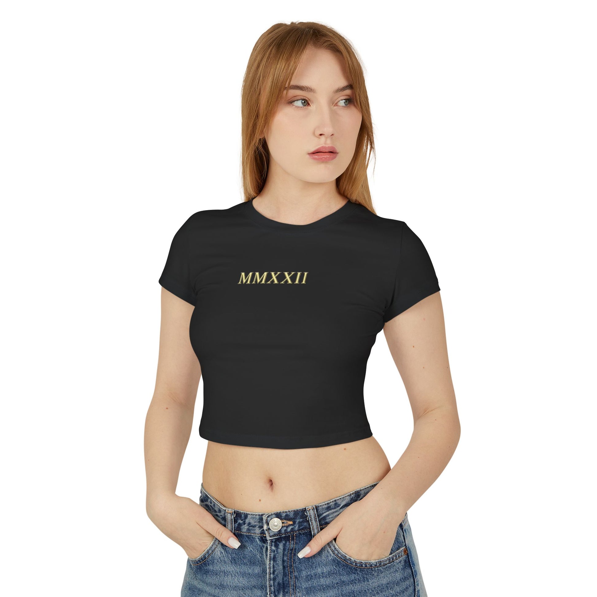 Gold sun medallion printed on the back of a cropped organic cotton baby tee