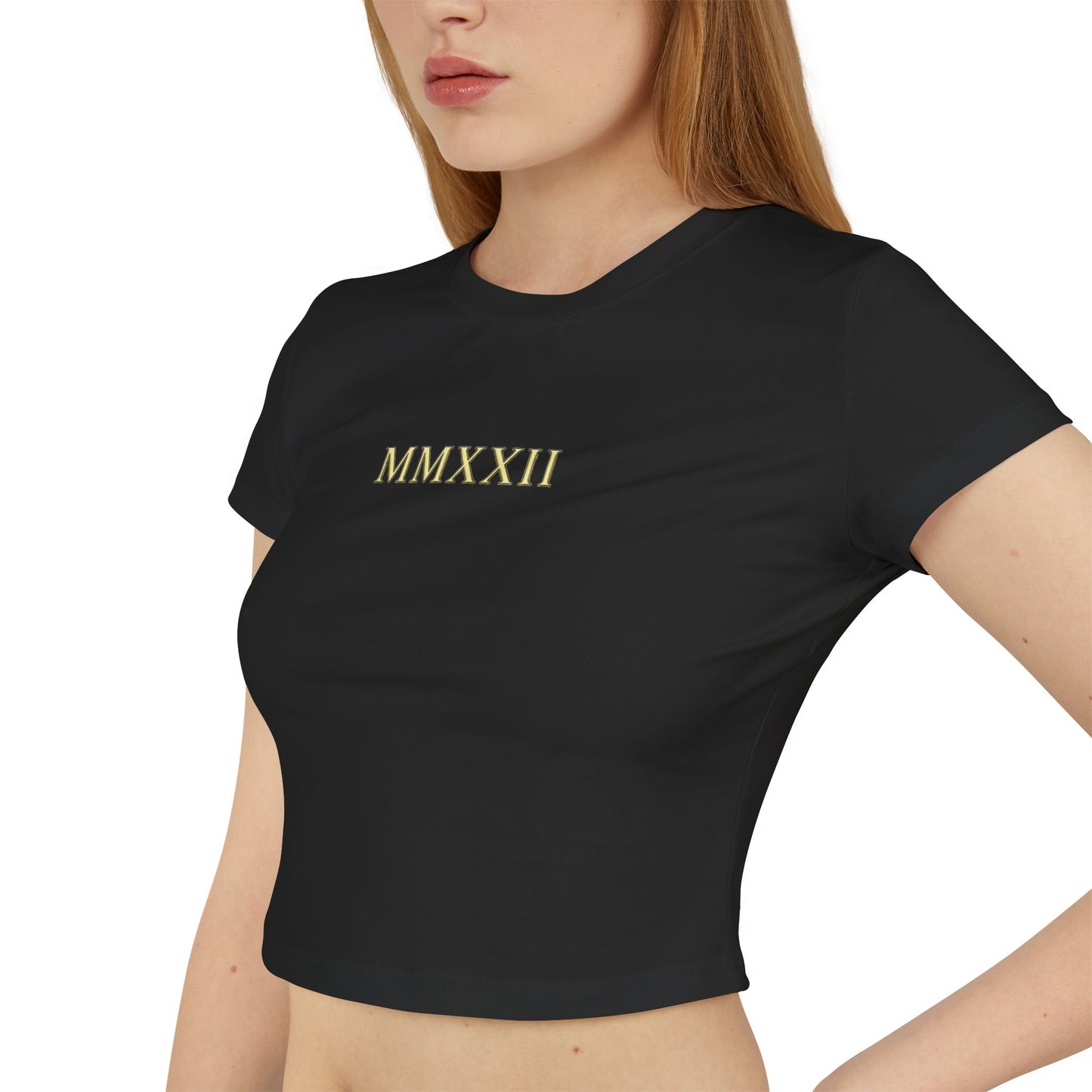 Gold sun medallion printed on the back of a cropped organic cotton baby tee