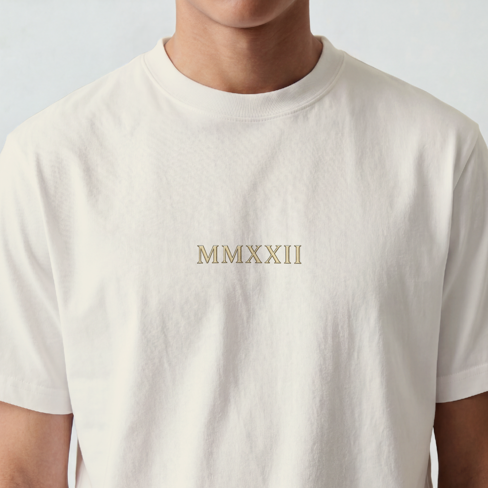 Hand-drawn gold laurel wreath printed on the back of a garment-dyed heavyweight cotton tee