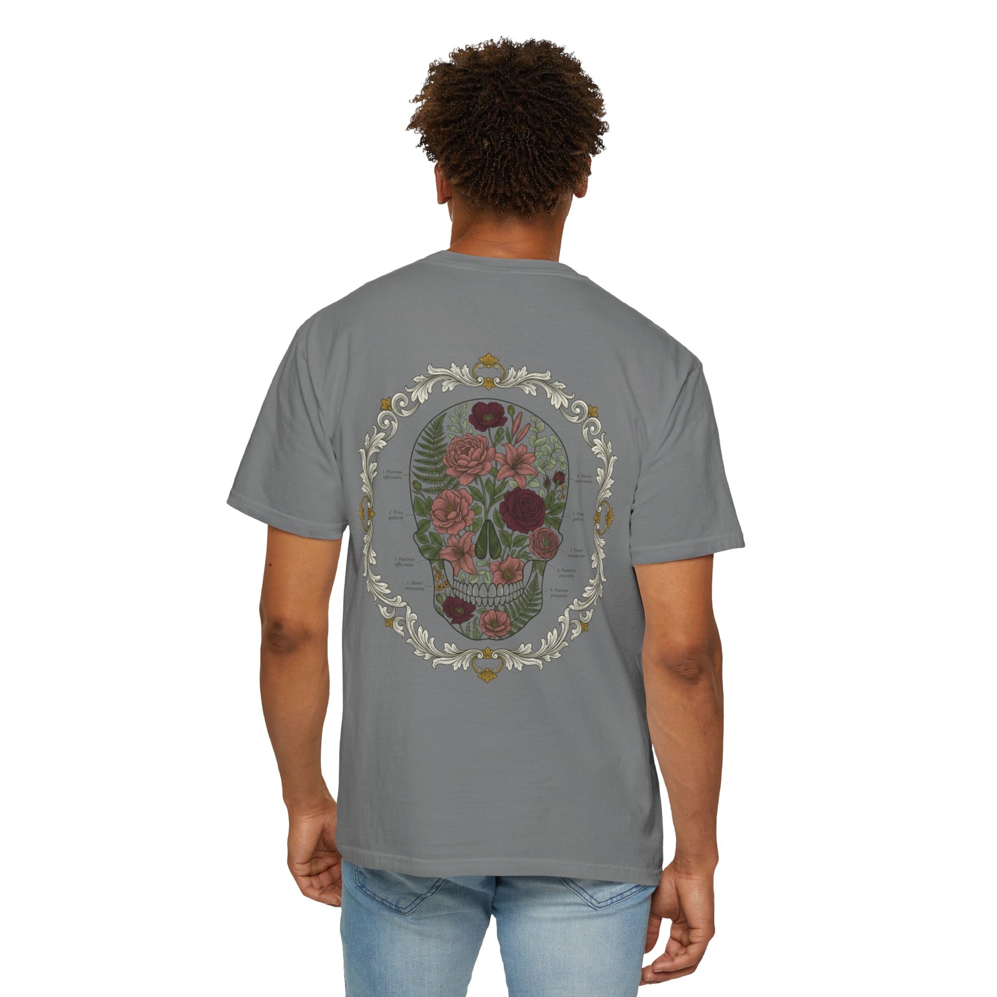 Floral skull framed in botanical scrollwork printed on the back of a garment-dyed cotton tee
